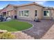 Backyard features a low-maintenance artificial lawn, desert landscaping, and outdoor seating area at 19765 N Swan Ct, Maricopa, AZ 85138