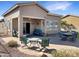 Backyard features covered patio, brick pavers, desert landscaping and outdoor seating at 19765 N Swan Ct, Maricopa, AZ 85138