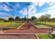 Active bocce ball courts with green turf and bright overhead lighting at 19765 N Swan Ct, Maricopa, AZ 85138