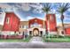 An eye-catching building featuring an arched entryway, decorative lighting, and a meticulously maintained lawn at 19765 N Swan Ct, Maricopa, AZ 85138