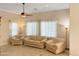 Cozy living room featuring neutral paint, tiled floors, and a ceiling fan at 19765 N Swan Ct, Maricopa, AZ 85138