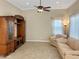 Cozy living room featuring neutral paint, tiled floors, and a wood entertainment center at 19765 N Swan Ct, Maricopa, AZ 85138