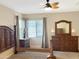 Spacious main bedroom featuring carpeted floors, neutral paint, and a ceiling fan at 19765 N Swan Ct, Maricopa, AZ 85138