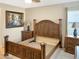 Neutral primary bedroom featuring an ornate bed frame, ceiling fan, and art at 19765 N Swan Ct, Maricopa, AZ 85138