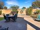 Inviting outdoor patio with brick pavers, desert landscaping and an arrangement of outdoor seating at 19765 N Swan Ct, Maricopa, AZ 85138