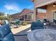 Spacious covered patio featuring brick pavers, comfortable seating and desert landscaping at 19765 N Swan Ct, Maricopa, AZ 85138