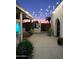 Private backyard with custom BBQ, string lights, a mature palm, succulents, and comfortable seating at 2002 E Mitchell Dr, Phoenix, AZ 85016