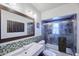 Bathroom with a modern sink, decorative mirror, and a tiled shower and tub with glass door at 2002 E Mitchell Dr, Phoenix, AZ 85016