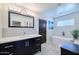 Bright bathroom with a dark vanity, stand alone tub and marble tile flooring at 2002 E Mitchell Dr, Phoenix, AZ 85016