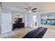 A primary bedroom features a mounted TV on the wall above a dark wood dresser at 2002 E Mitchell Dr, Phoenix, AZ 85016