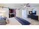 A primary bedroom features a sliding closet door and TV above a dark wood dresser at 2002 E Mitchell Dr, Phoenix, AZ 85016