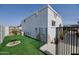 Casita exterior featuring artificial grass, decorative rock and a wrought-iron fence at 2002 E Mitchell Dr, Phoenix, AZ 85016