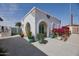 Casita exterior featuring a white stucco facade, decorative brick accents and arched doorways at 2002 E Mitchell Dr, Phoenix, AZ 85016