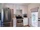 A bright kitchen featuring white shaker cabinets and stainless steel appliances at 2002 E Mitchell Dr, Phoenix, AZ 85016