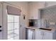 A bright kitchen featuring white shaker cabinets and stainless steel appliances at 2002 E Mitchell Dr, Phoenix, AZ 85016