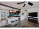 Open-concept kitchen with a large island, dark wood cabinets, and stainless steel appliances open to the living room at 2002 E Mitchell Dr, Phoenix, AZ 85016