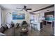 Inviting living room with a brown leather sofa, ceiling fan, and a view into the modern kitchen with an island at 2002 E Mitchell Dr, Phoenix, AZ 85016