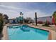 Inviting backyard with a sparkling blue pool and views of the home and landscaping at 2002 E Mitchell Dr, Phoenix, AZ 85016