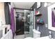 Modern bathroom features walk-in shower with black and gray tile, floating shelves, and stylish fixtures at 2061 E Bayberry Ave, Mesa, AZ 85204