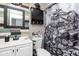 Eclectic bathroom with unique wallpaper, statement mirror, and updated vanity at 2061 E Bayberry Ave, Mesa, AZ 85204