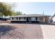 Charming single-story home featuring a stone facade, well-maintained landscaping, and a covered parking area at 2061 E Bayberry Ave, Mesa, AZ 85204