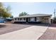 Inviting single-story home with a well-manicured yard, concrete driveway, and charming curb appeal at 2061 E Bayberry Ave, Mesa, AZ 85204