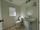 Powder room featuring modern toilet, sink, and fixtures at 2107 N 77Th Dr, Phoenix, AZ 85035