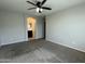 Primary bedroom with ensuite bathroom, carpet, neutral walls, and ceiling fan at 2107 N 77Th Dr, Phoenix, AZ 85035