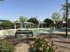 Community pool area with water features, shaded seating, and lush landscaping at 2107 N 77Th Dr, Phoenix, AZ 85035