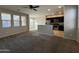 Spacious living room featuring large windows and an open floor plan to the kitchen at 2107 N 77Th Dr, Phoenix, AZ 85035