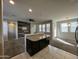 View from the kitchen into the open living room with an accent wall at 2107 N 77Th Dr, Phoenix, AZ 85035