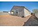 Exterior view of the home's backyard with gravel, and some lawn equipment at 214 N 190Th Dr, Buckeye, AZ 85326