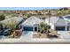 Charming single-story home features a two-car garage, desert landscaping, and a tile roof with solar panels at 214 N 190Th Dr, Buckeye, AZ 85326