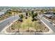 This high-angle view shows a green open space with mature trees surrounded by a residential neighborhood at 214 N 190Th Dr, Buckeye, AZ 85326