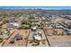 Aerial view of a home with a vast landscape and horse training space in a beautiful neighborhood at 22005 N 86Th Ave, Peoria, AZ 85383