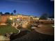 Lush backyard featuring a pool, outdoor kitchen, and a cozy seating area under a charming pergola at 22005 N 86Th Ave, Peoria, AZ 85383