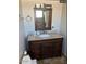 Bathroom featuring a granite vanity and a shower with a neutral tile surround at 22005 N 86Th Ave, Peoria, AZ 85383