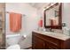 Bathroom featuring a dark wood vanity, granite counters, and warm neutral decor at 22005 N 86Th Ave, Peoria, AZ 85383