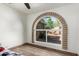 Bedroom featuring a unique arched window and wood laminate flooring at 22005 N 86Th Ave, Peoria, AZ 85383