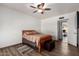 Well-lit bedroom with wood flooring and a ceiling fan at 22005 N 86Th Ave, Peoria, AZ 85383