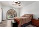 Bedroom with a large window, neutral walls, and a ceiling fan at 22005 N 86Th Ave, Peoria, AZ 85383