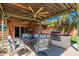 Relaxing covered patio with outdoor dining area, ceiling fans, and a built-in grill at 22005 N 86Th Ave, Peoria, AZ 85383