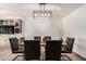 Contemporary dining room with stylish light fixture and views of the adjoining living space at 22005 N 86Th Ave, Peoria, AZ 85383