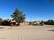 A charming single-story home with mature tree, circular driveway, and an American flag at 22005 N 86Th Ave, Peoria, AZ 85383