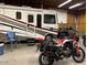 Garage containing RV and motorcycle, offering ample storage and hobby space at 22005 N 86Th Ave, Peoria, AZ 85383