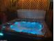 Relaxing hot tub with LED lights and waterfall feature for evening enjoyment at 22005 N 86Th Ave, Peoria, AZ 85383