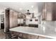 Kitchen featuring modern stainless steel appliances, wood cabinets, and an island with white counters at 22005 N 86Th Ave, Peoria, AZ 85383