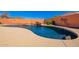 Inviting backyard pool with a rock waterfall feature and ample tanning deck space at 22005 N 86Th Ave, Peoria, AZ 85383