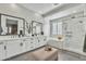 Well-lit bathroom with double vanity, soaking tub, glass shower, and modern marble tile accents at 2205 E Fallen Leaf Ln, Phoenix, AZ 85024