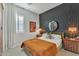 This bedroom includes textured accent wall and natural light, enhancing the relaxing atmosphere at 2205 E Fallen Leaf Ln, Phoenix, AZ 85024